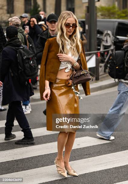 Leonie Hanne is seen wearing a brown Miu Miu jacket, white blouse, brown Miu Miu skirt, tan shoes and brown and gold Miu Miu bag outside the Miu Miu...