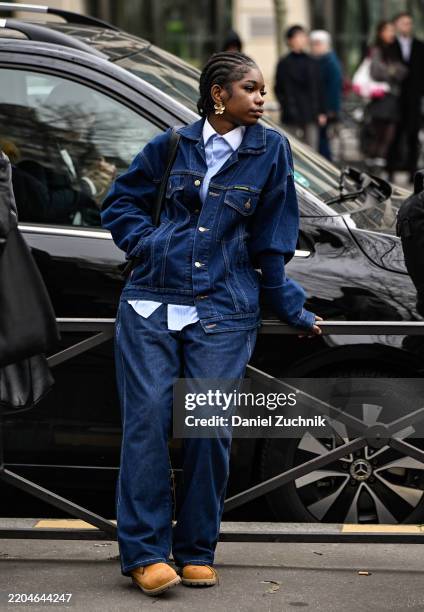 Guest is seen wearing a jean jacket and pants, Timberland boots and outside the Miu Miu show during the Womenswear Fall/Winter 2025/2026 as part of...