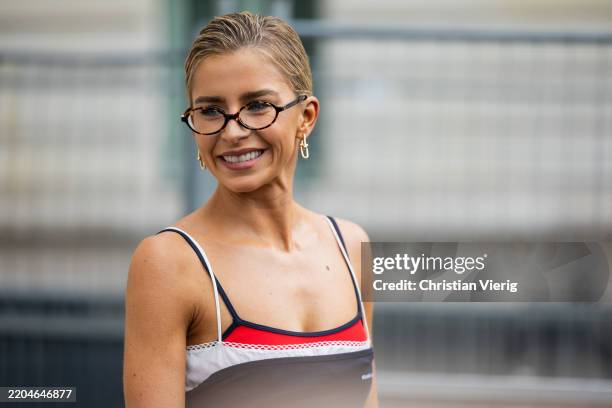 Caroline Caro Daur wears glasses, nav red shirt outside Miu Miu during the Womenswear Fall/Winter 2025/2026 as part of Paris Fashion Week on March...