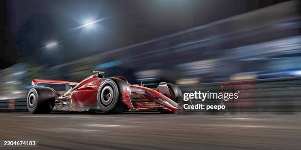 rennwagen bewegt sich bei nachtrennen schnell - autosport stock-fotos und bilder