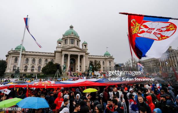 Protesters waves with flags in front of National Assembling while marching into Belgrade on March 15, 2025 in Belgrade, Serbia. In recent weeks, tens...