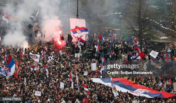 Protesters waves with flags while marching into Belgrade on March 15, 2025 in Belgrade, Serbia. In recent weeks, tens of thousands of people have...