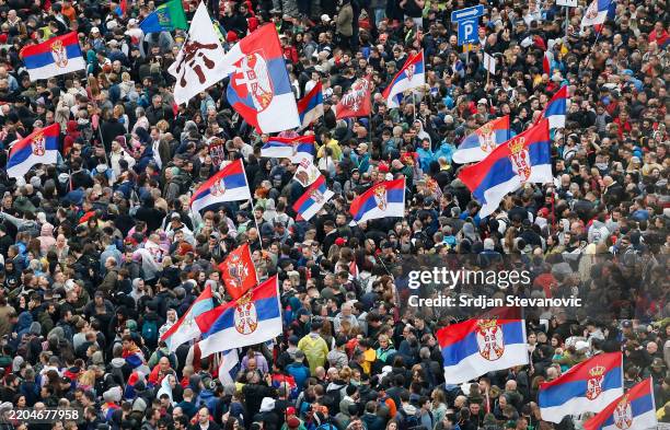 Protesters waves with flags while marching into Belgrade on March 15, 2025 in Belgrade, Serbia. In recent weeks, tens of thousands of people have...