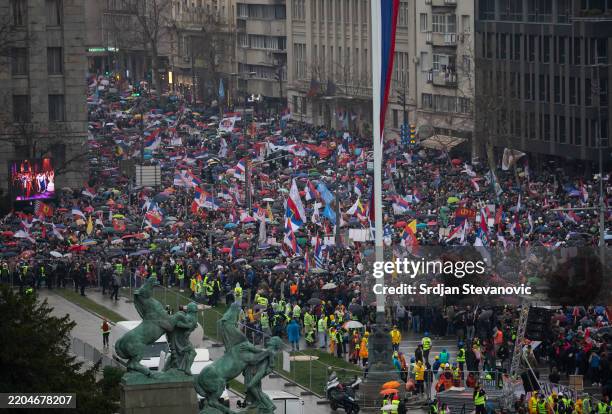 Protesters waves with flags while marching into Belgrade on March 15, 2025 in Belgrade, Serbia. In recent weeks, tens of thousands of people have...