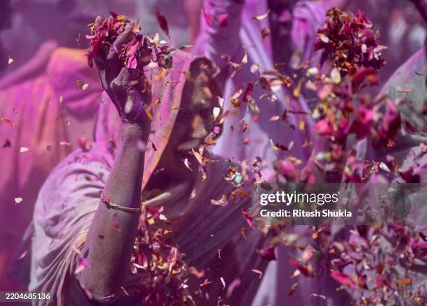 Widows covered in flower petals and colour celebrate Holi on March 12, 2025 in Vrindavan, India. In Vrindavan, the traditional Holi celebration for...