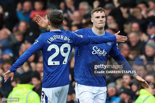Everton's Irish defender Jake O'Brien celebrates with Everton's Danish midfielder Jesper Lindstrom after scoring their first goal during the English...