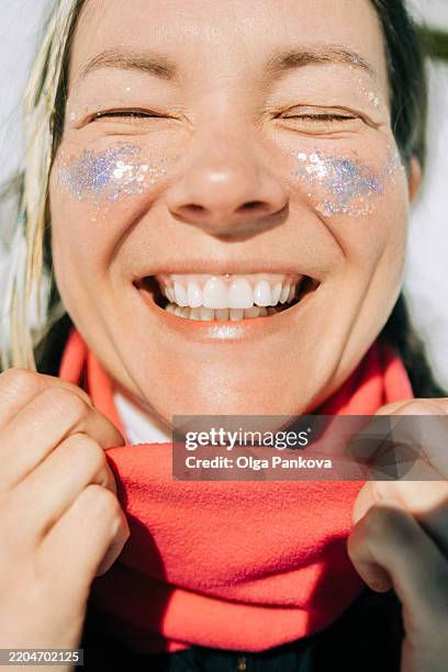 close-up portrait of smiling woman with glitter makeup on a sunny day - glitter face stock pictures, royalty-free photos & images