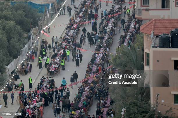 Hundreds of Palestinians break their fast during a mass iftar program at Nuseirat Refugee Camp in Deir al-Balah, Gaza on March 15, 2025.
