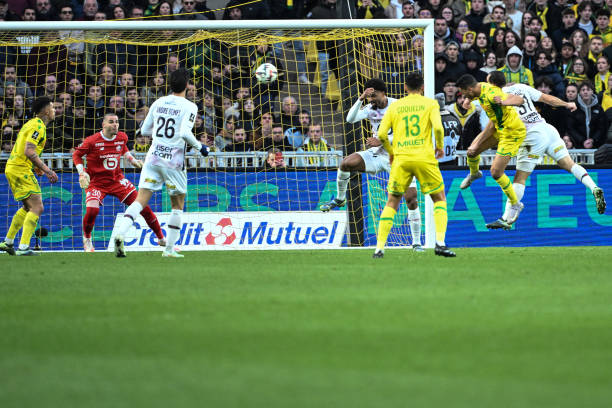 Nantes' Egyptian forward Mostafa Mohamed heads the ball to score his team's first goal during the French L1 football match between FC Nantes and...