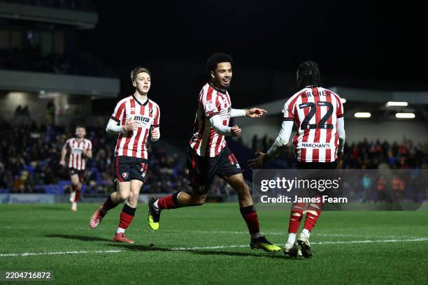 Ashley Hay of Cheltenham Town celebrates with teammate Ethon Archer after scoring his team's first goal during the Sky Bet League Two match between...