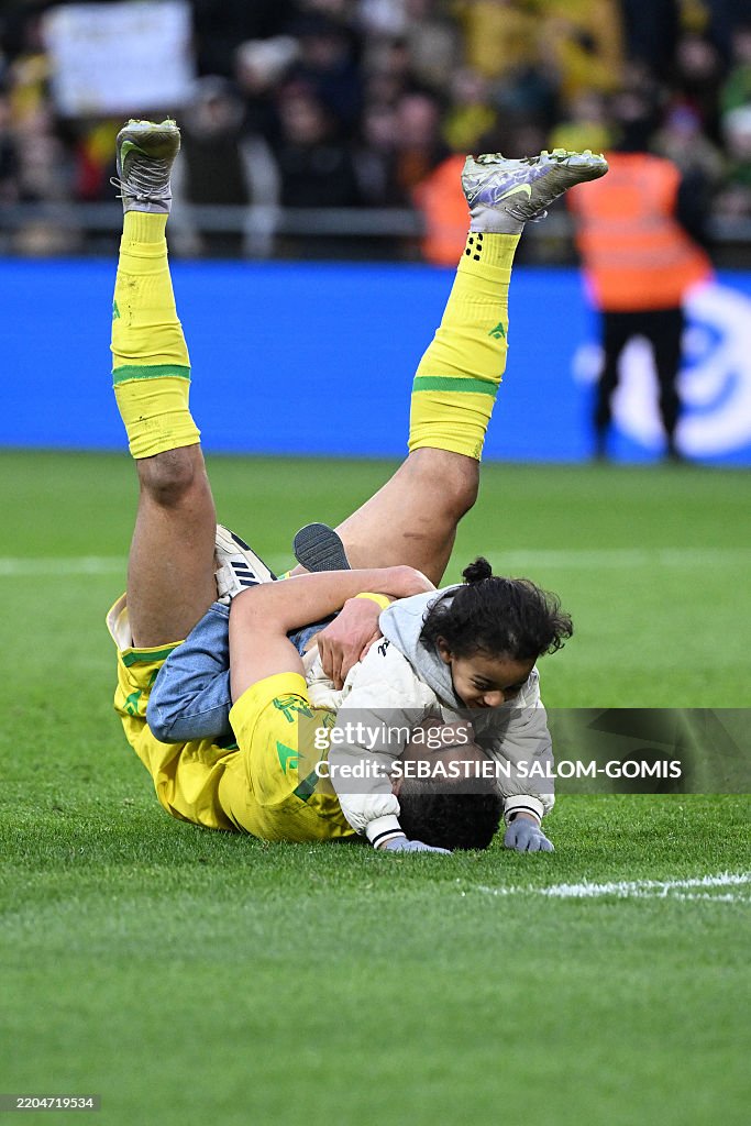 Mostafa Nantes' Egyptian forward Mostafa Mohamed celebrates with his daughter ...