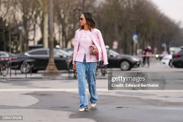 Aimee Song wears black sunglasses, gold earrings, white dark pink pattern tweed buttoned Chanel blazer jacket, white dark pink pattern tweed buttoned...