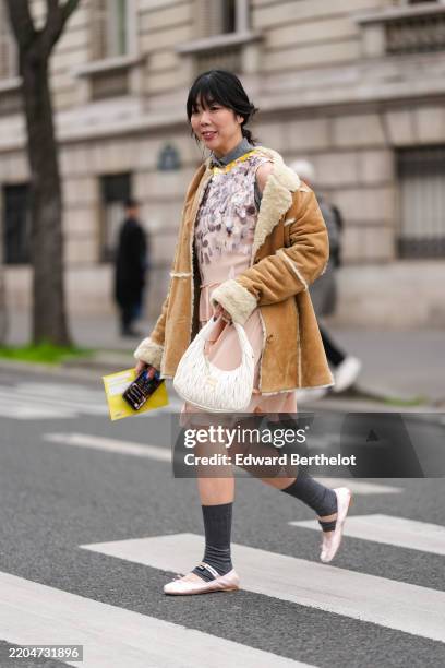 Susie Lau wears dark gray polo sleeveless Miu Miu shirt, light pink dark purple sequin sleeveless Miu Miu midi dress, light brown cream faux fur...