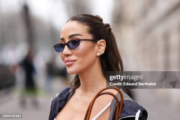 Tamara Kalinic wears black sunglasses, silver earrings, outside Miu Miu, during the Paris Fashion week Women's Fall/Winter 2025-2026 on March 11,...