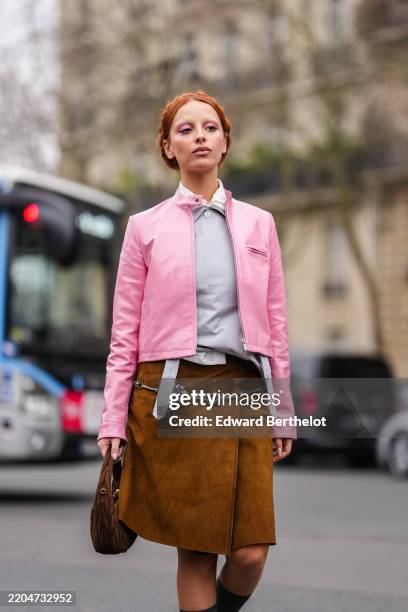 Marie Gaguech wears dark orange braided hair, white bleached eyebrows, dark pink eyeshadow, white collar Miu Miu shirt, light gray Miu Miu shirt,...