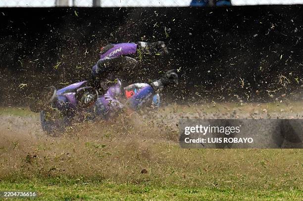 Prima Pramac Yamaha's Portuguese rider Miguel Oliveira skids off the track after crashing with BK8 Gresini Racing MotoGP's Spanish rider Fermin...