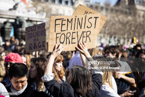Demonstrator holds a placard that says "Feminist Forever" during the demonstration of the International Women's Rights Day. According to the...