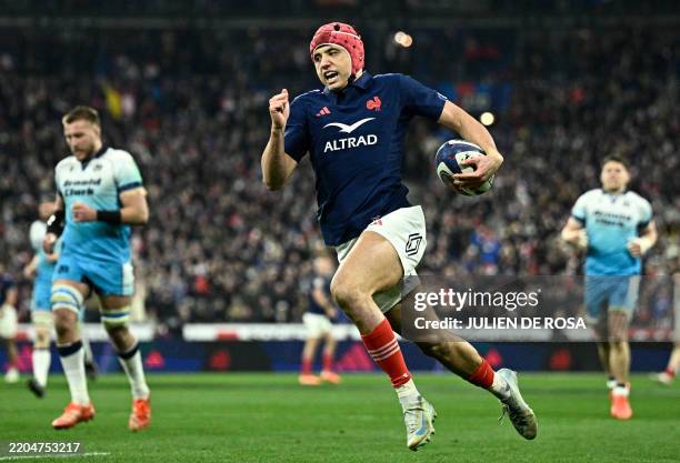 France's wing Louis Bielle-Biarrey runs to score the team's second try during the Six Nations international rugby union match between France and...