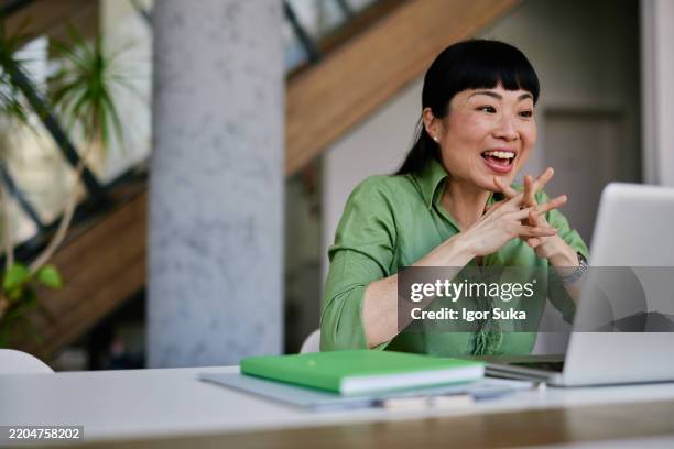 Enthusiastic Japanese Businesswoman Having A Video Call On Laptop, Stockfoto