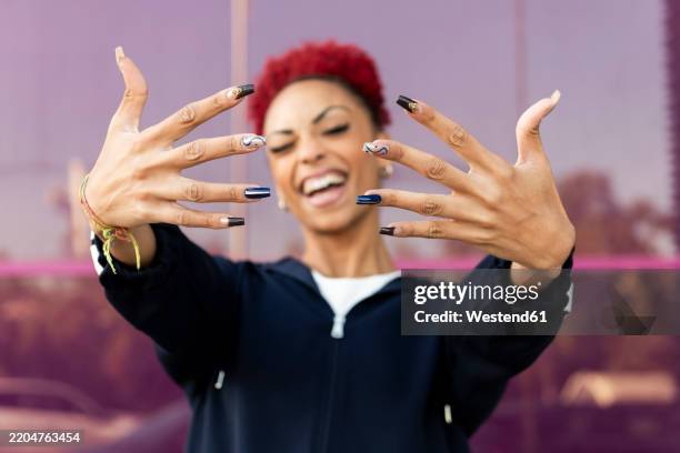 happy woman showing long nails at street - long fingernails imagens e fotografias de stock