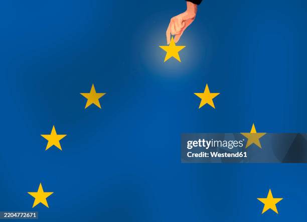 hand picking star from european flag - europaflagge stock-grafiken, -clipart, -cartoons und -symbole