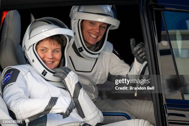 Astronaut commander Anne McClain, and NASA astronaut pilot Nichole Ayers laugh with family members, friends and guests while exiting the Neil A....