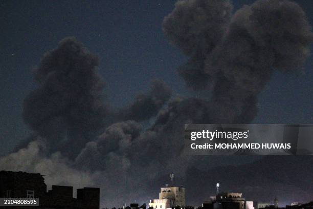 Plume of smoke billows during a US strike on Yemen's Huthi-held capital Sanaa early on March 16, 2025. The first US strikes against Yemen's Huthis...