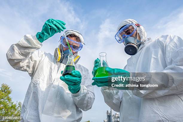 male biologists examining quality of water. - toxicology stock pictures, royalty-free photos & images
