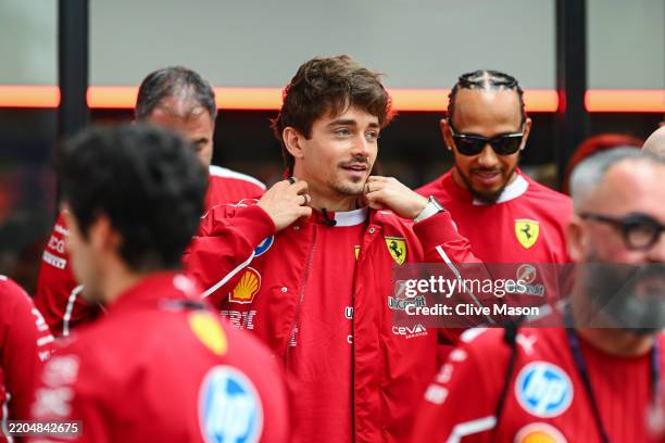 Charles Leclerc of Monaco and Scuderia Ferrari and Lewis Hamilton of Great Britain and Scuderia Ferrari in the garage during previews ahead of the F1...