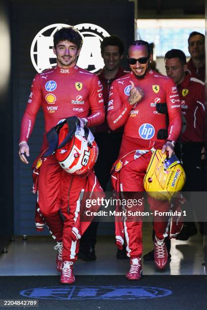 Charles Leclerc of Monaco and Scuderia Ferrari and Lewis Hamilton of Great Britain and Scuderia Ferrari in the FIA garage during previews ahead of...