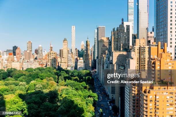 skyscrapers of fifth avenue and 59th street surrounding central park in summer, new york city, usa - upper east side manhattan stock pictures, royalty-free photos & images