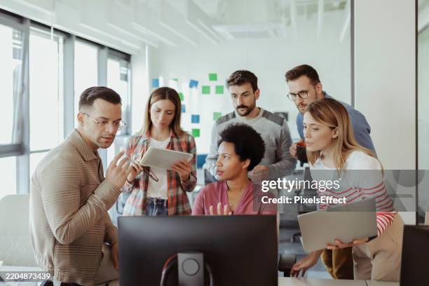 future of tech: programmers crafting code in a bright office - software development team stock pictures, royalty-free photos & images