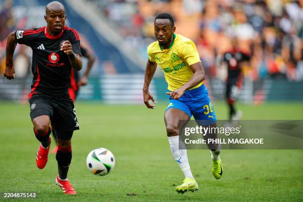 Pirates' South African defender Nkosinathi Sibisi runs for the ball with Sundowns' Namibian forward Peter Shalulile during the Premier Soccer League...