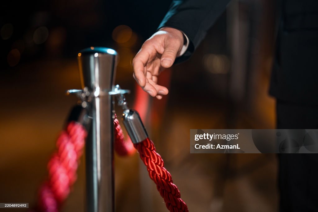 Security Rope Guards Closeup Of Male Security Guards Hand Outdoors Holding Red Rope Under ...