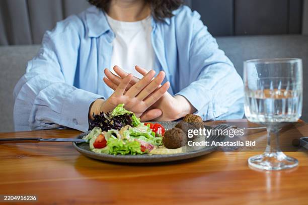 anonymous woman refuse from food.eating disorder concept. - no appetite stock pictures, royalty-free photos & images
