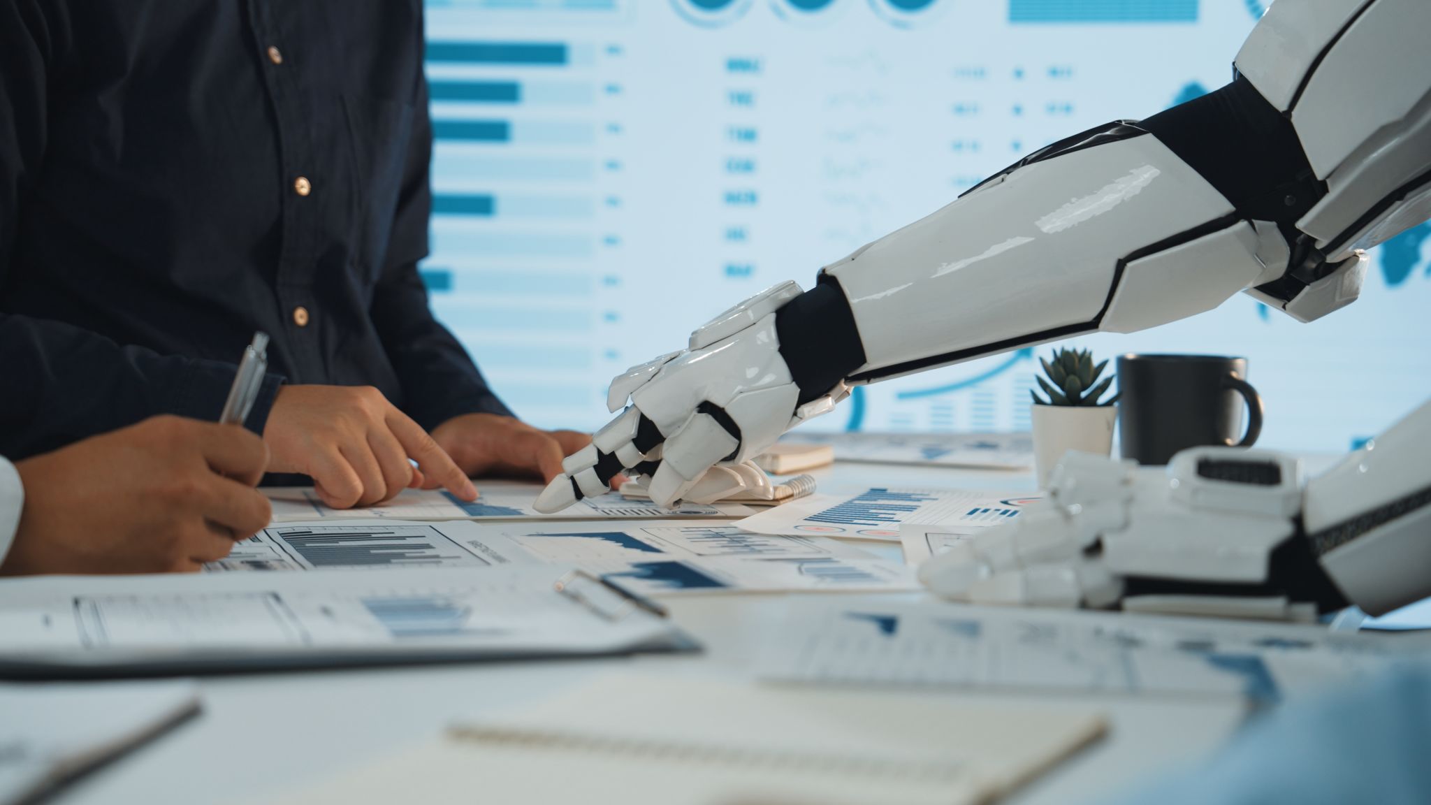 Advanced Technology Integration in Business: A Collaborative Workspace Featuring a Robot Arm Helping Human Colleagues Analyze Data and Charts. Noogenesis Advanced Technology Integration in Business: A Collaborative Workspace Featuring a Robot Arm Helping Human Colleagues Analyze Data and Charts. Noogenesis