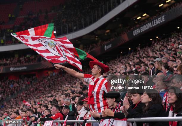 Fan of Athletic Club shows their support, waving a flag during the UEFA Europa League 2024/25 Round of 16 Second Leg match between Athletic Club and...