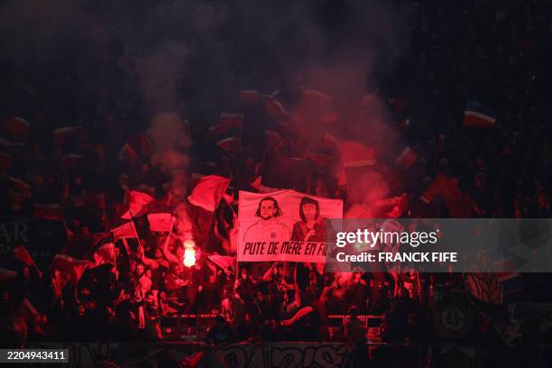 S supporters hold an insulting banner depicting Marseille's French midfielder Adrien Rabiot and his mother Veronique Rabiot, reading "whore from...