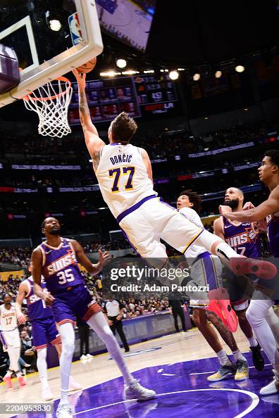 Fuyj Luka Doncic of the Los Angeles Lakers drives to the basket during the ...