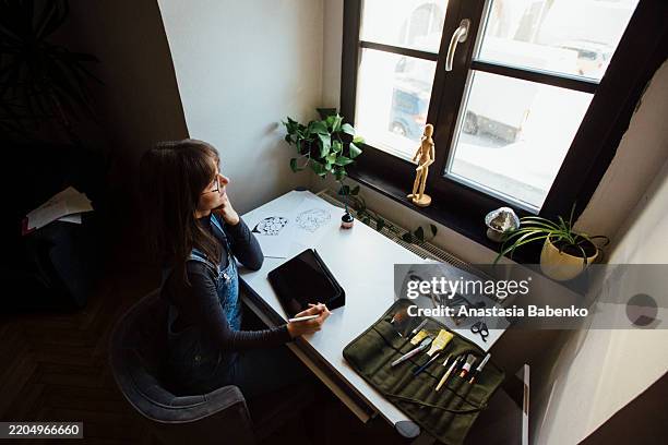 woman working on tablet with art supplies - hand stylus stock pictures, royalty-free photos & images