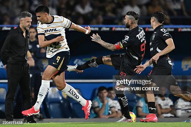 Pumas' forward Guillermo Martinez is fouled by Monterrey's Spanish defender Sergio Ramos during the Liga MX Clausura football match between Pumas and...