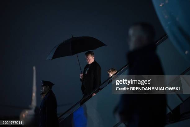 Elon Musk and his son X Æ A-12 step off of Air Force One upon arrival at Joint Base Andrews in Maryland, on March 17, 2025. Musk is travelling with...