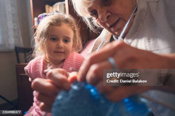 grandma teaches her granddaughter how to knit - knitting stock pictures, royalty-free photos & images