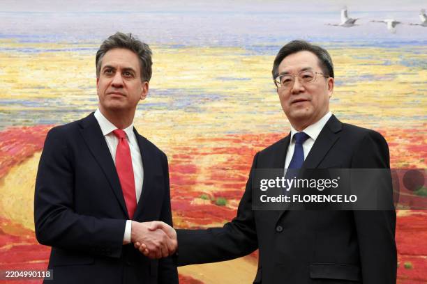 Britain's Energy Secretary Ed Miliband and China's Vice Premier Ding Xuexiang shake hands before their meeting at the Great Hall of the People in...