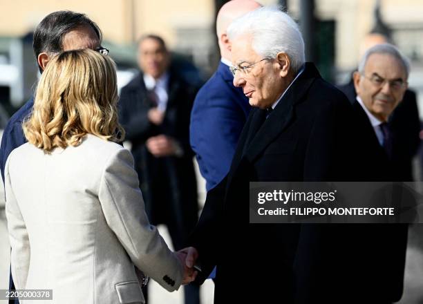 Italy's Prime Minister, Giorgia Meloni shakes hands with Italy's President Sergio Mattarella as they arrive at the Altare della Patria monument for...