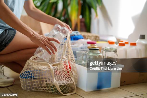 sorting recyclables for a sustainable lifestyle - circulaire economie stockfoto's en -beelden