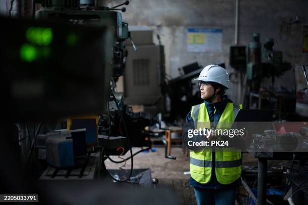aisan female working on laptop in factory - aisan women stock pictures, royalty-free photos & images