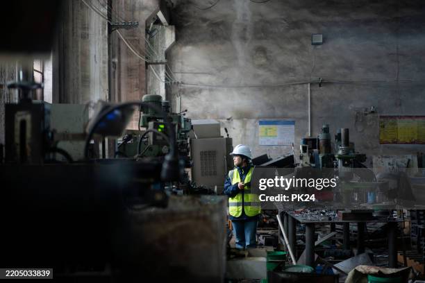 aisan female working on laptop in factory - aisan women stock pictures, royalty-free photos & images