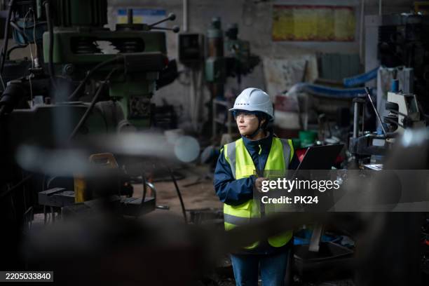 aisan female working on laptop in factory - aisan women stock pictures, royalty-free photos & images