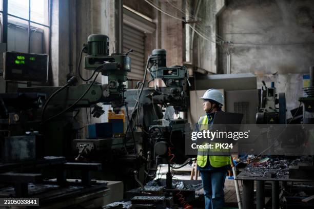 aisan female working on laptop in factory - aisan women stock pictures, royalty-free photos & images